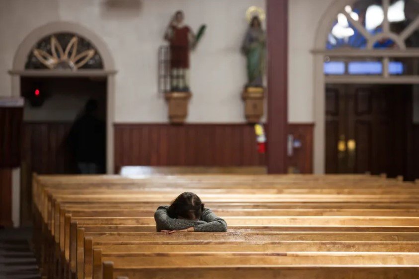 A parishioner prays in a church in Texas.